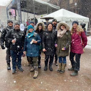 Members of the Bent Water Brewing Team gather and pose, as its snowing, for a photo during the 2022 Winter Walk 